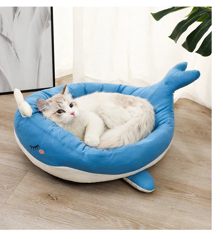 Blue duck-shaped fluffy pet bed for a small dog on a wooden floor.