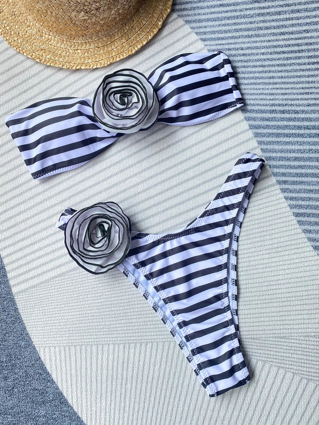 Black and white striped bikini swimsuit with a tube top and a split skirt bottom.