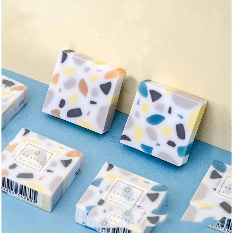 A single brick-shaped white rubber eraser for removing pencil marks.