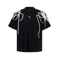 Black women's short-sleeve T-shirt with rivet ribbon detail on padded shoulder.
