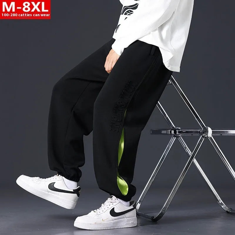 Men's grey green cotton casual trousers with white collage stitching detail and an elasticated ankle band.