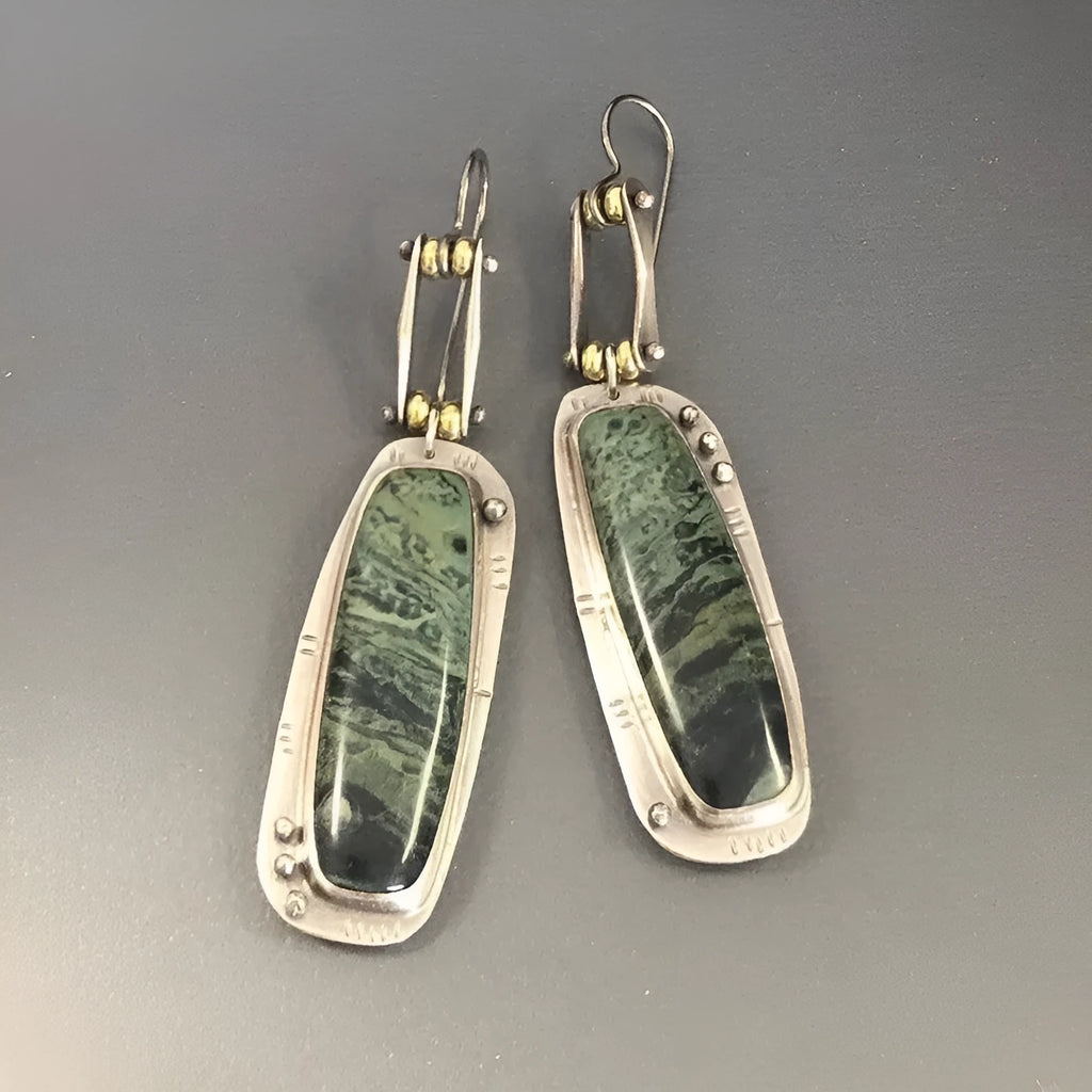 Pair of two-colour marble pattern geometric alloy earrings on simple background