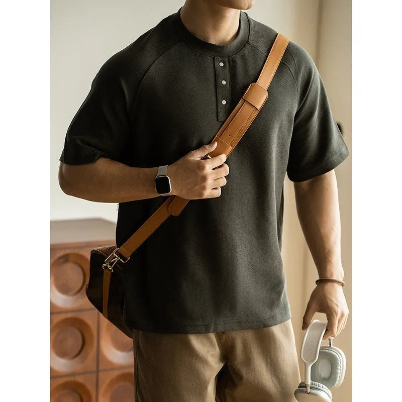 Casual loose-fitting grey pullover top with raglan sleeves and a textured terry fabric.
