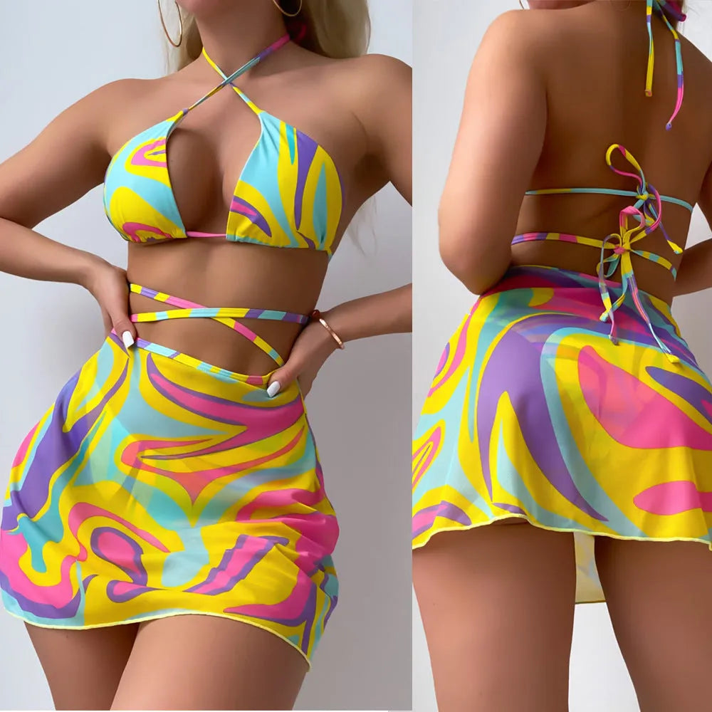 Yellow striped women's halter swimsuit with lace-up front, shown with matching high-waisted skirt and shorts.