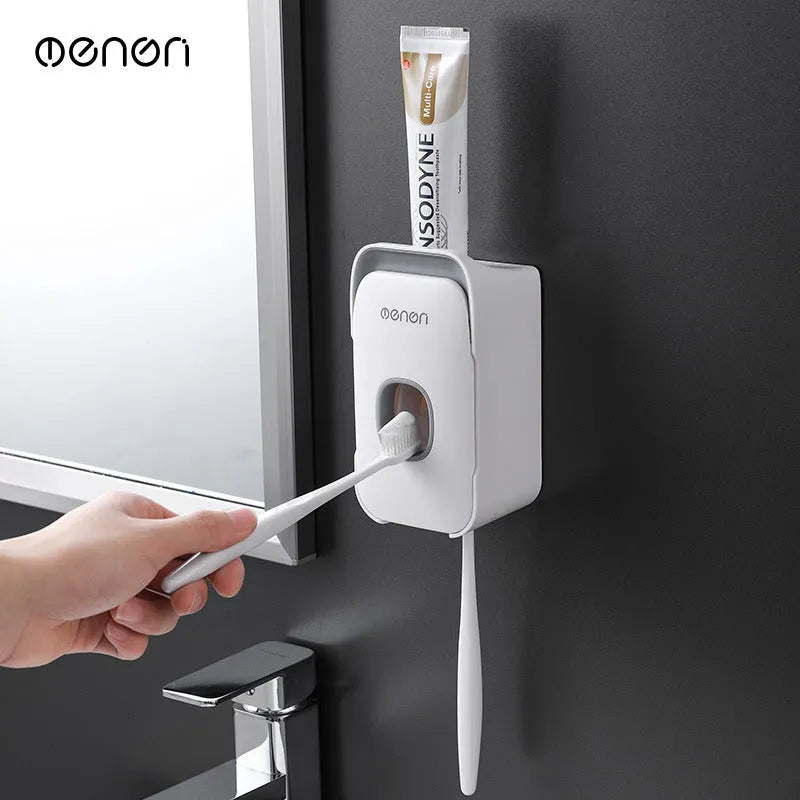 Blue automatic toothpaste dispenser with wall-mount bracket on a bathroom wall