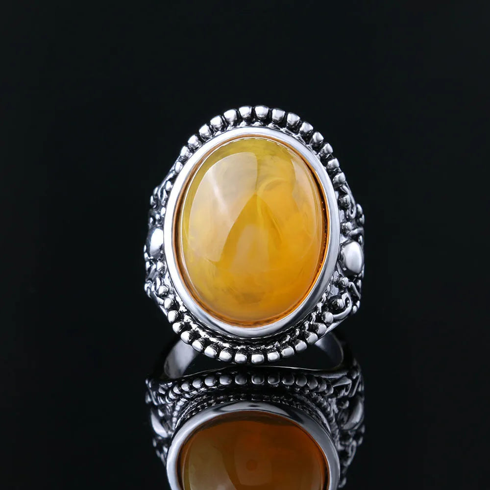 Fluorescent beeswax centre geometric ring in antique silver on a hand.