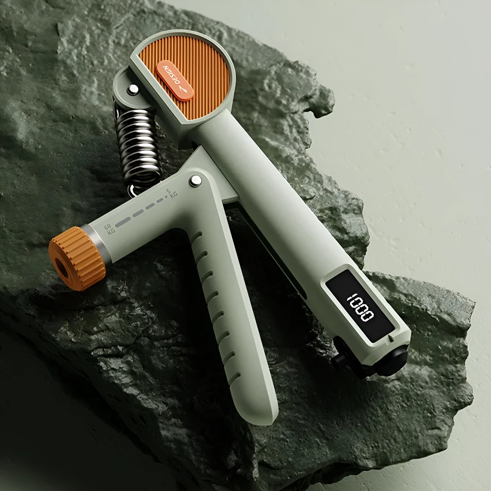 Adjustable ABS plastic spring hand grip in ivory white, green, or black colours.