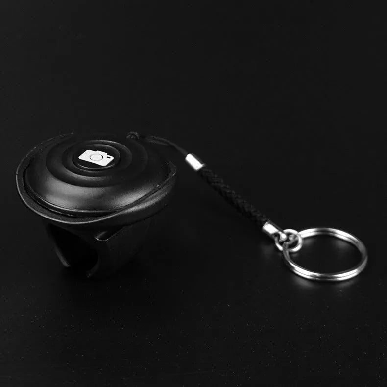 Black Bluetooth remote control for wireless selfie photography with smartphone connection
