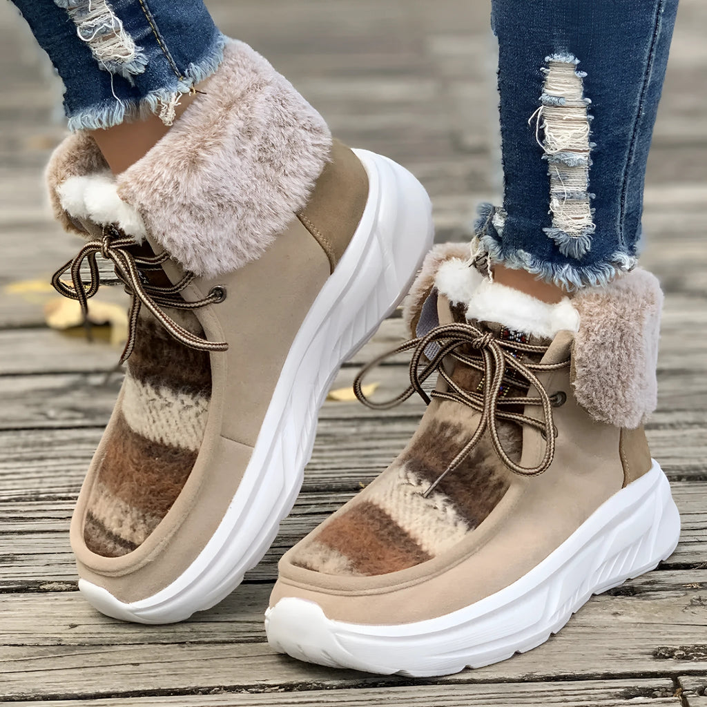 Beige women's lace-up snow boots with a suede upper, thick rubber sole, and plush lining.