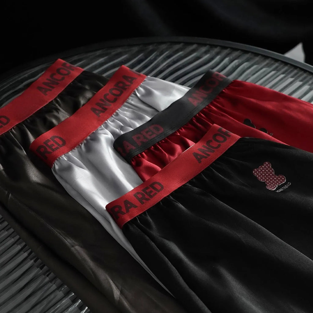 Solid colour men's boxer briefs in knitted polyester fabric on a mid waist mannequin.