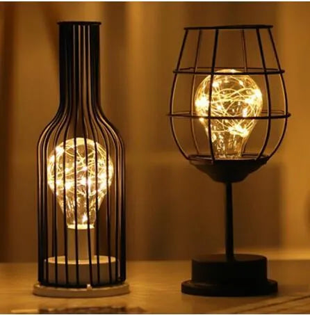 Minimalist hollow iron table lamp in wine bottle design with warm white LED lighting