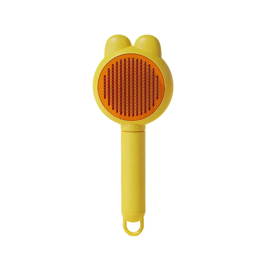 Green pet grooming brush with a release button and stainless steel teeth on a non-slip handle.