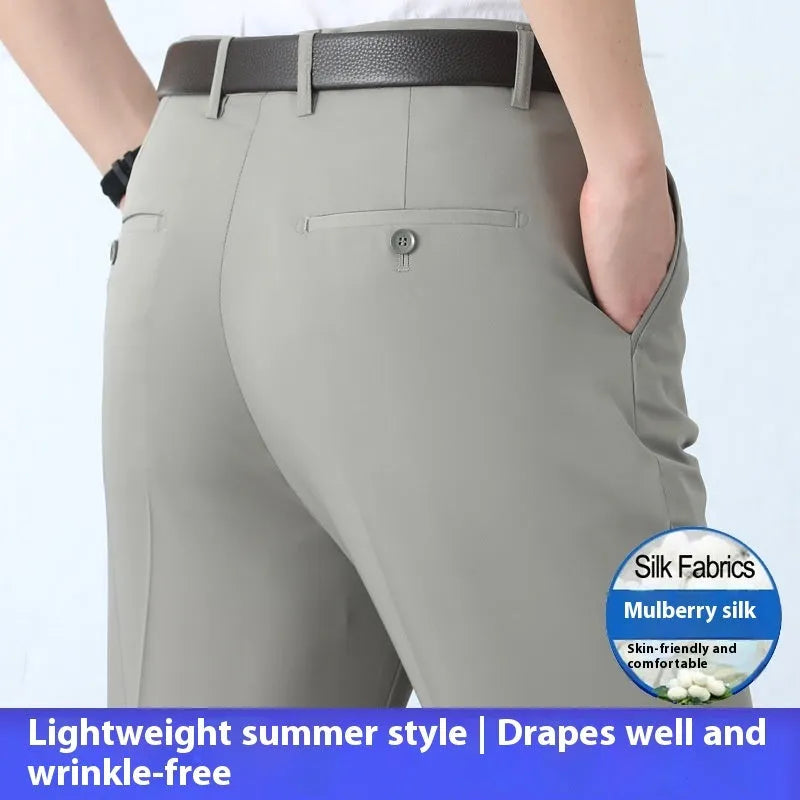 Men's straight-leg suit trousers in a dark blue colour, showing high waist and business cut.