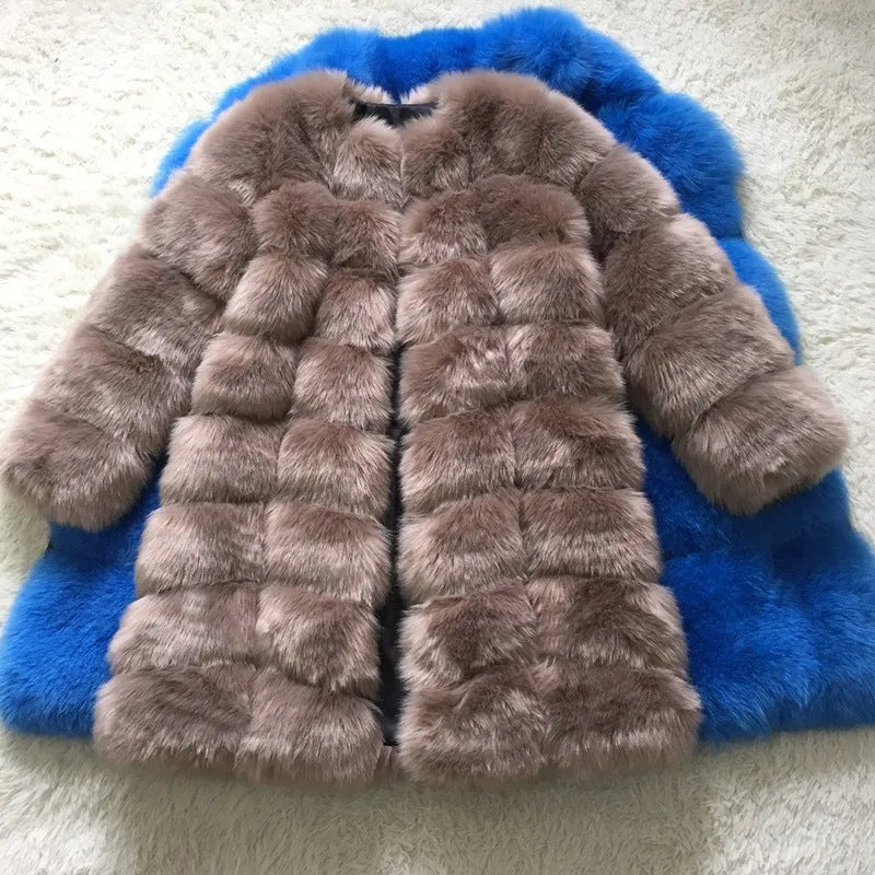 Women's long black artificial fur winter coat with regular sleeves on a hanger.