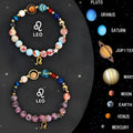 Set of two natural stone beaded bracelets on a table, showing zodiac sign designs and elastic string.
