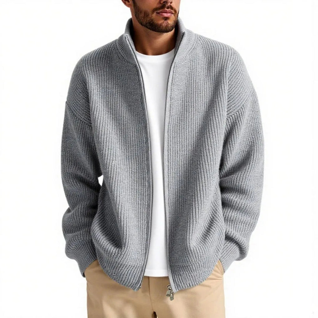 Man wearing a loose grey cardigan sweater with button-up front and V-neck.
