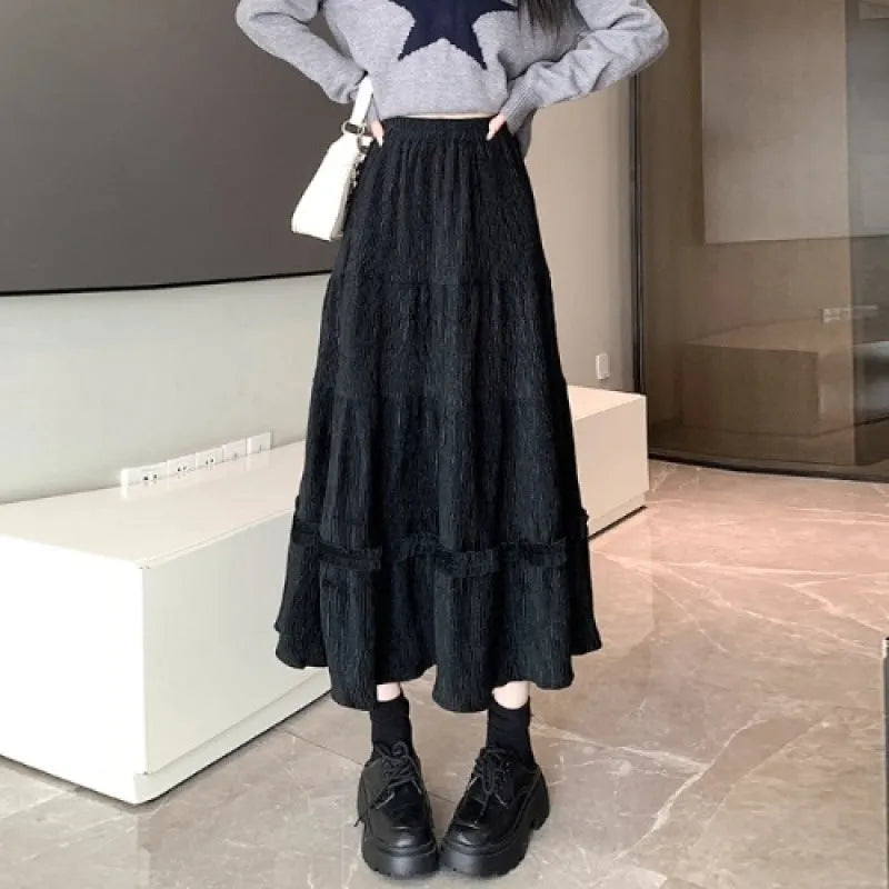 Korean style corduroy A-line midi skirt with elastic waistband in solid beige, black, or brown.