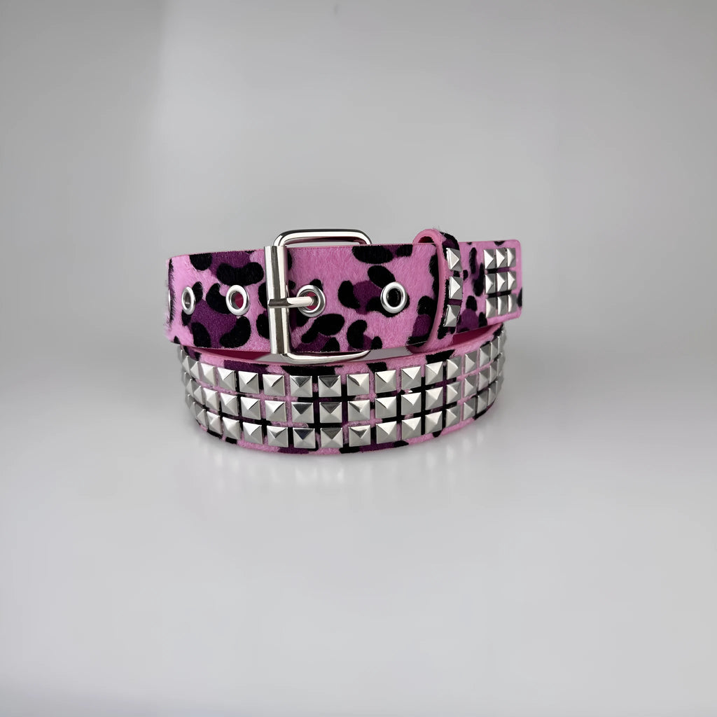 Women's punk fashion belt with metal rivets and pyramid studs in leopard print pattern, showing adjustable buckle