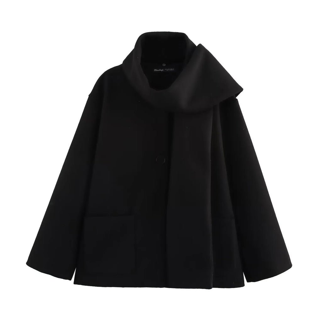 Women's long black polyester overcoat with a gray artificial fur collar, showing street fashion style and front pockets.