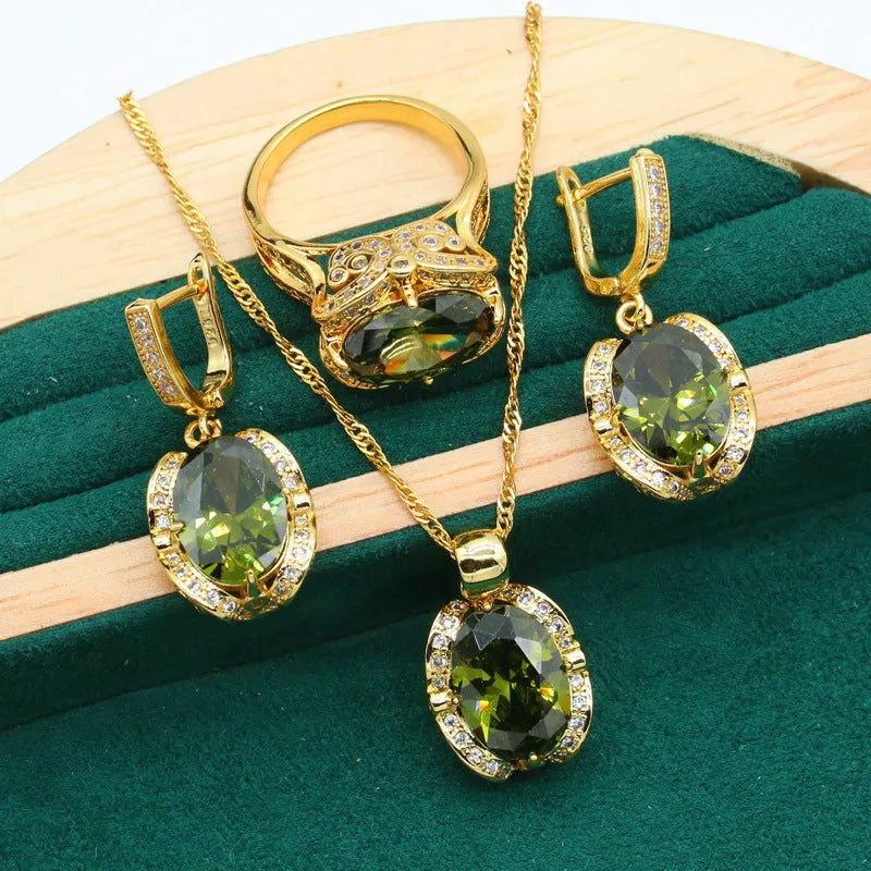 Olive green zircon rhinestone jewellery set on snake bone chain with crown pendant, plus matching earrings and ring.
