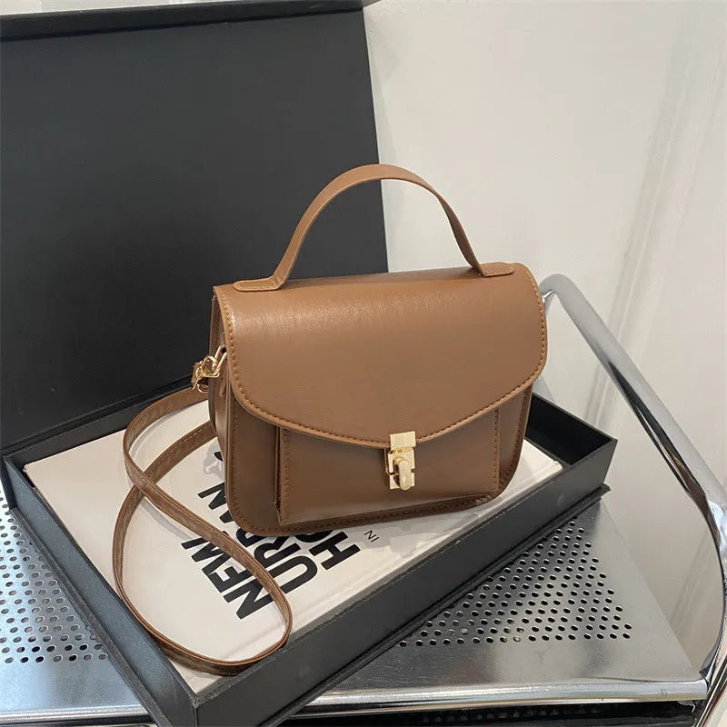 PU leather messenger bag in horizontal square shape with crossbody strap and document compartment