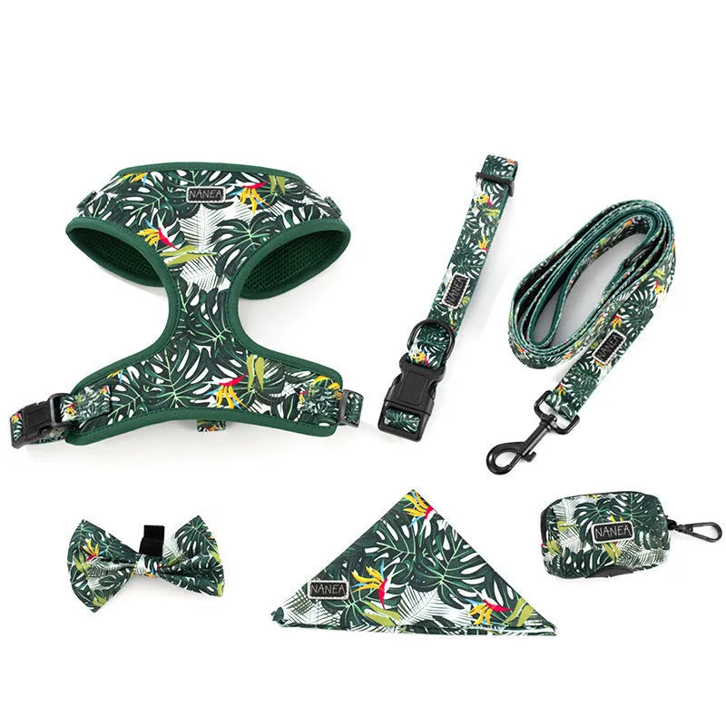 Six-piece pet harness set showing chest and back harness, hand-holding rope, collar, toilet bag, bow tie, and triangular scarf on a cloth background