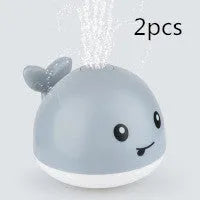 Automatic electric whale bath toy spraying water with flashing coloured lights
