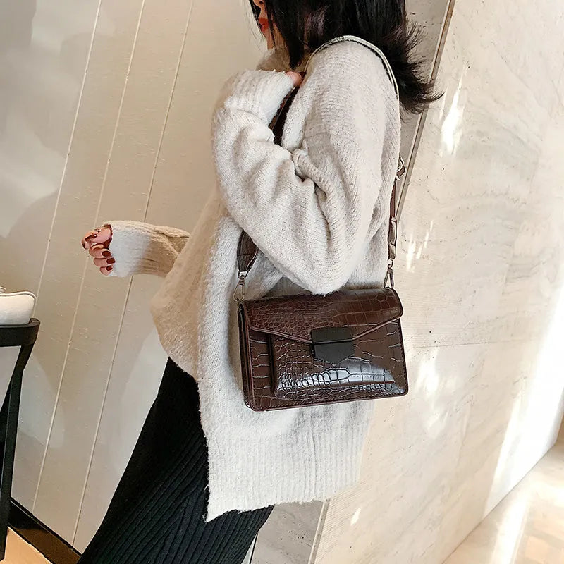 Vintage PU leather crossbody bag in black showing 20cm width and crossbody strap