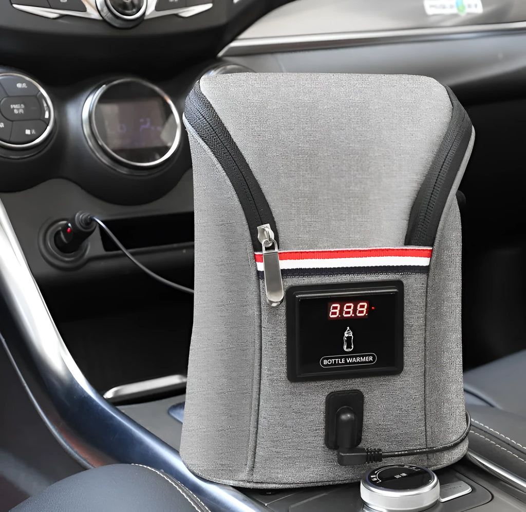 Grey portable car baby bottle warmer with dual slots and digital temperature display screen connected to 12V charger