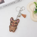 Close-up of a French dog-themed rhinestone keychain pendant with a cartoon bear design, in caramel colour.