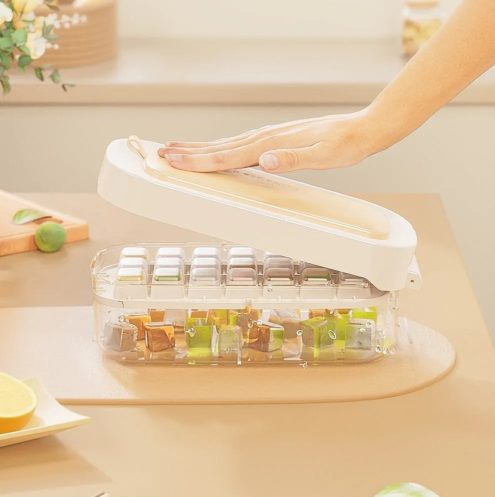 High-capacity plastic ice cube tray in blue with an ice shovel stored in a dedicated slot on the tray.