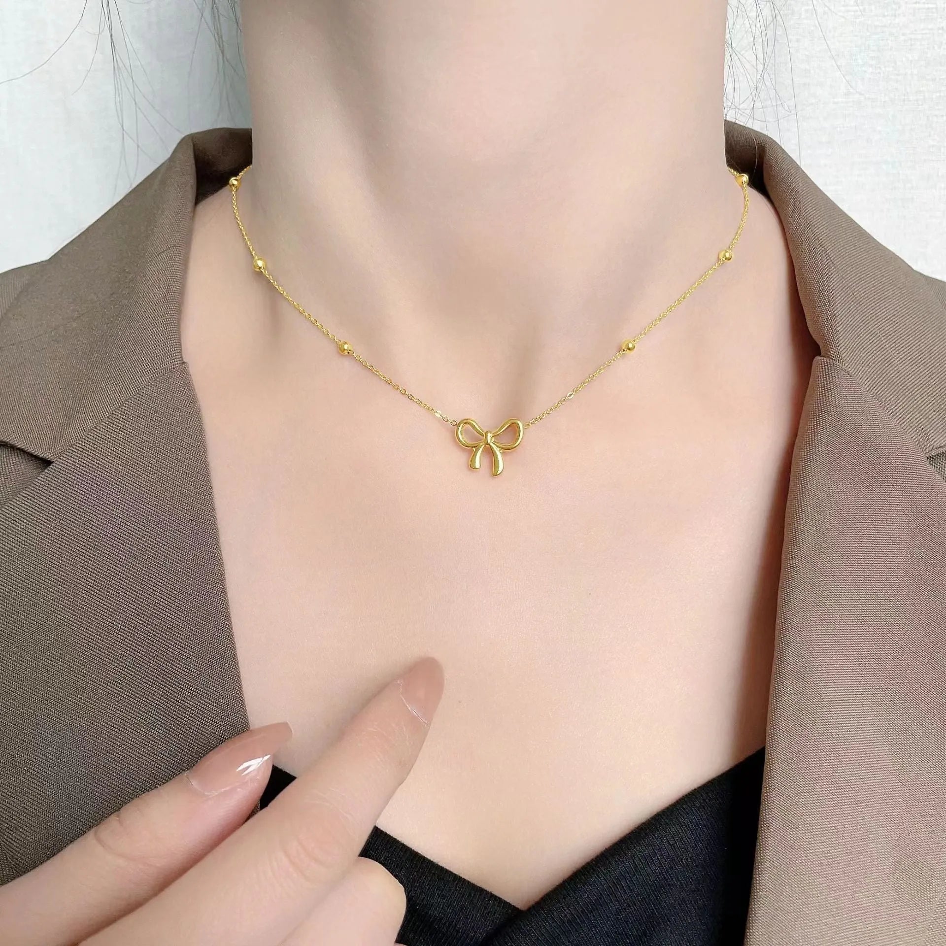 Gold bow necklace for women with cross chain design and adjustable length