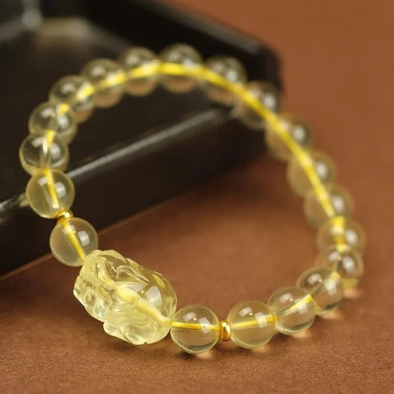 Yellow leather adjustable bracelet with citrine-coloured artificial crystal beads and a Chinese Pi Xiu charm.