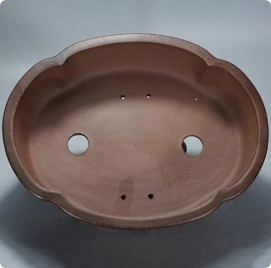 Classical purple clay flower pot for plants, shown on a tabletop.