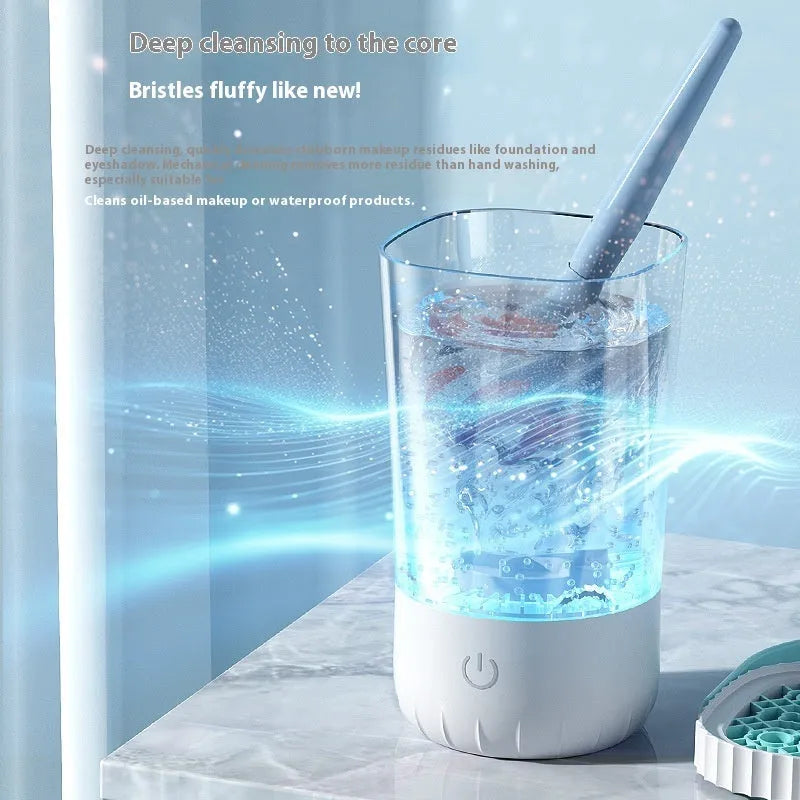 White rechargeable electric makeup brush cleaning tool with USB cable.