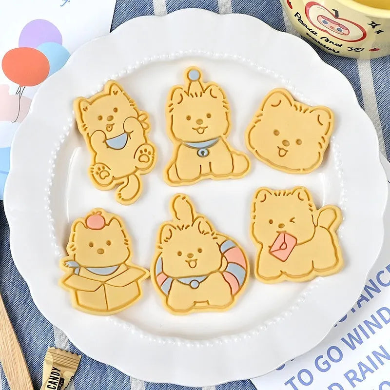 Three dimensional plastic biscuit mold with puppy cartoon designs including puppy head and birthday hat
