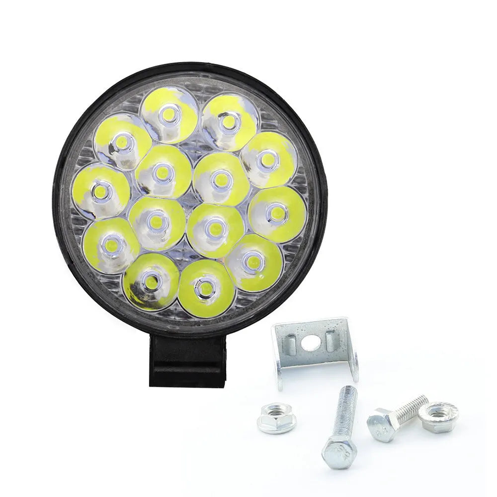 Compact round white LED work light with aluminium housing, suitable for mounting on a vehicle.