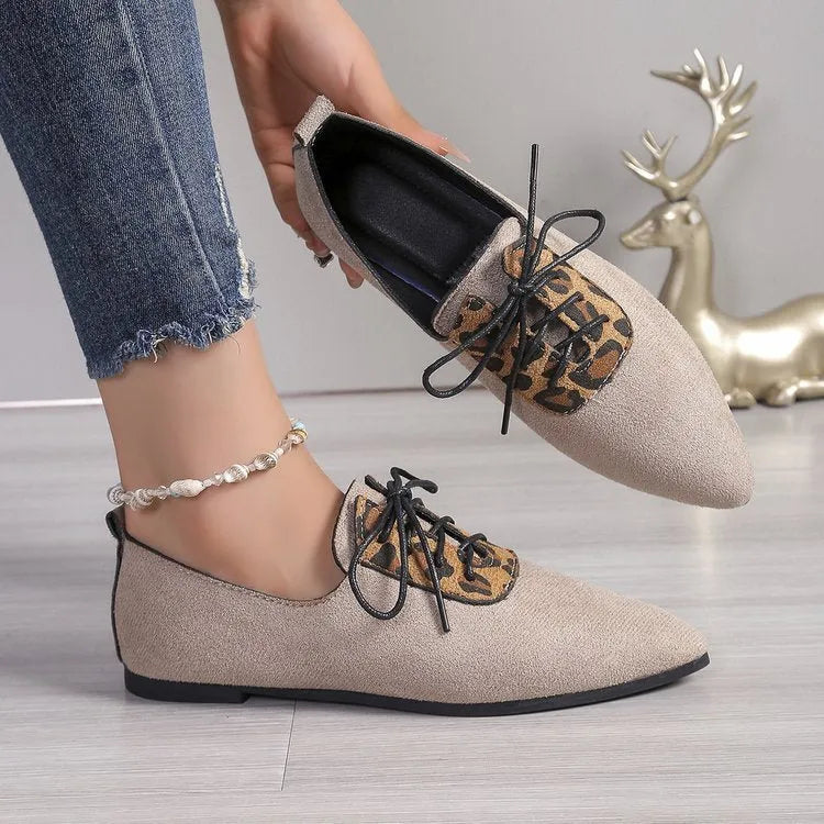 Beige leopard print women's pumps with a pointed toe, shown in a plus size.
