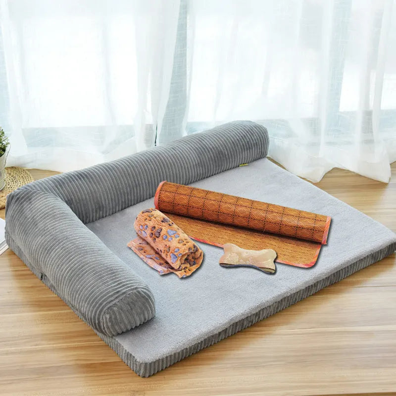 A corduroy dog sofa bed with raised sides, shown in a grey colour, placed on a wooden floor.