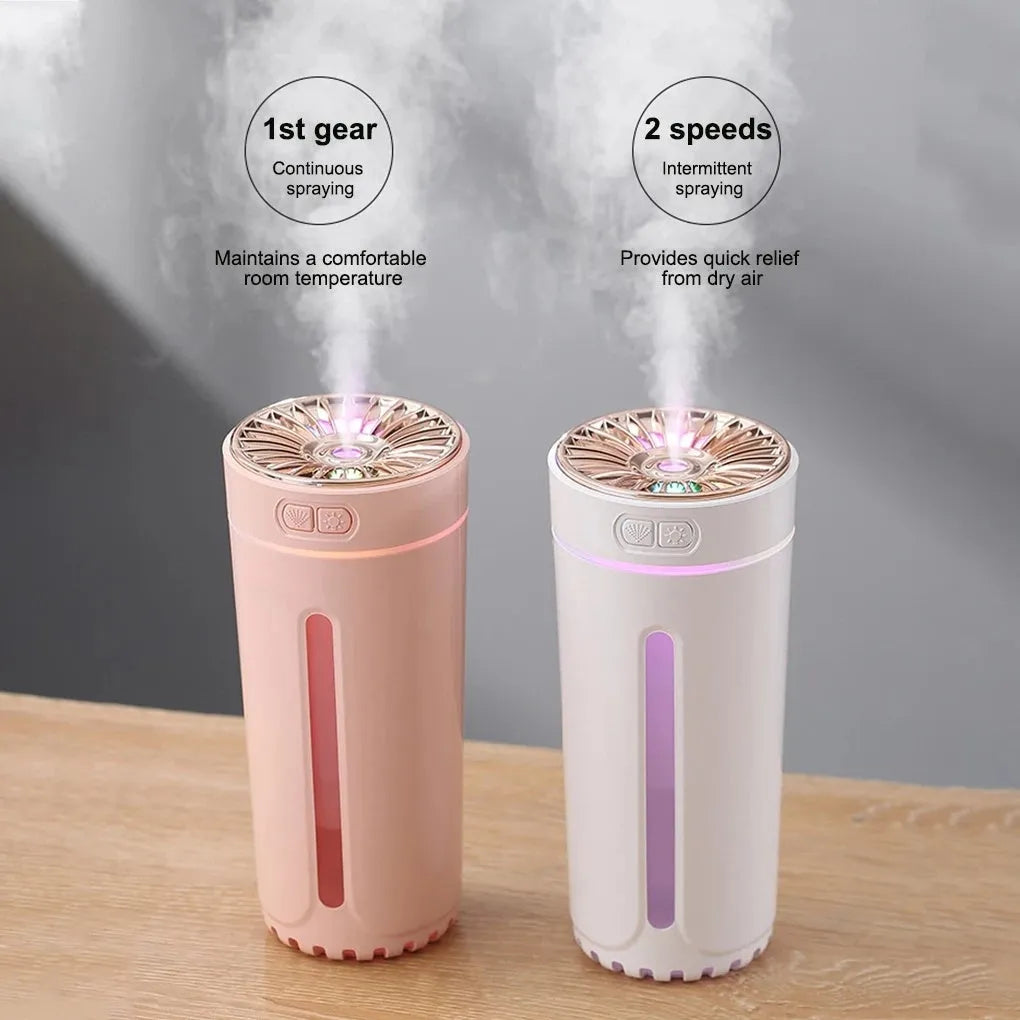 Black portable car humidifier with colourful LED lights on car cup holder showing mist output