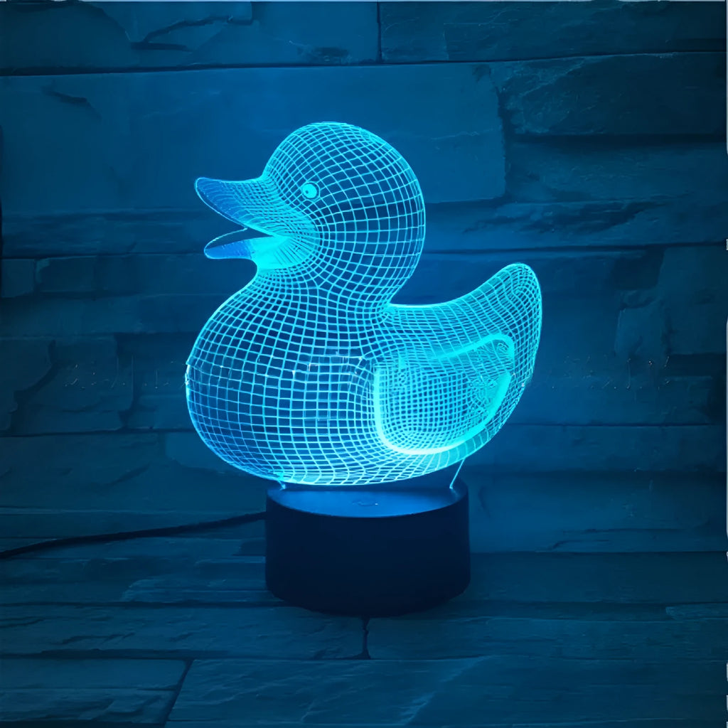 Little yellow duck 3D acrylic night light on ABS base with remote control, showing colour-changing LEDs.