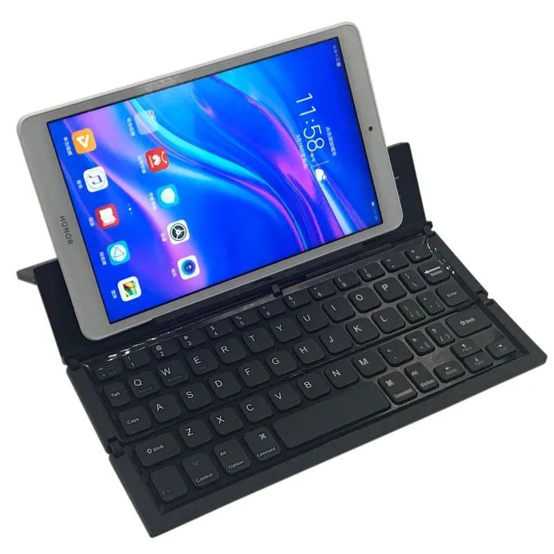 Black folding Bluetooth keyboard with numeric pad next to tablet