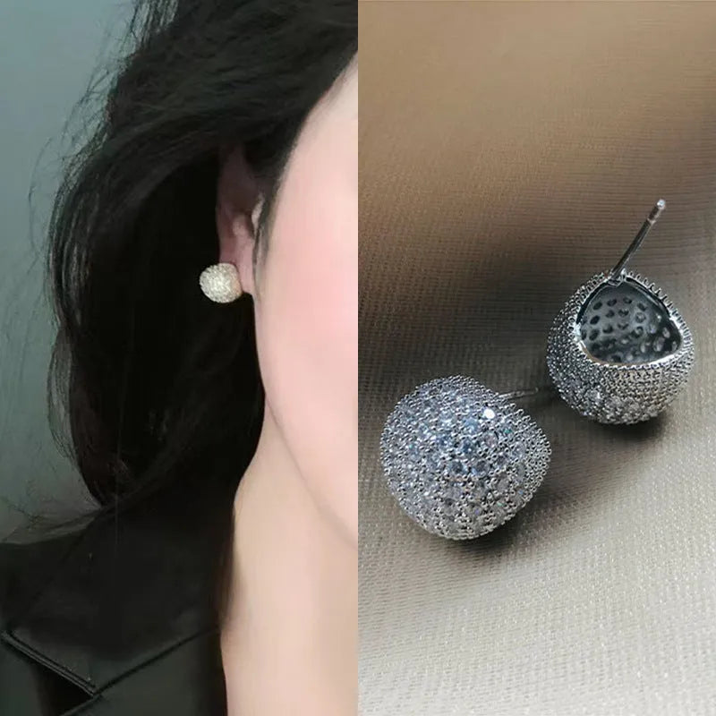 Golden beans drop-shaped earrings with full diamond embellishment and geometric design