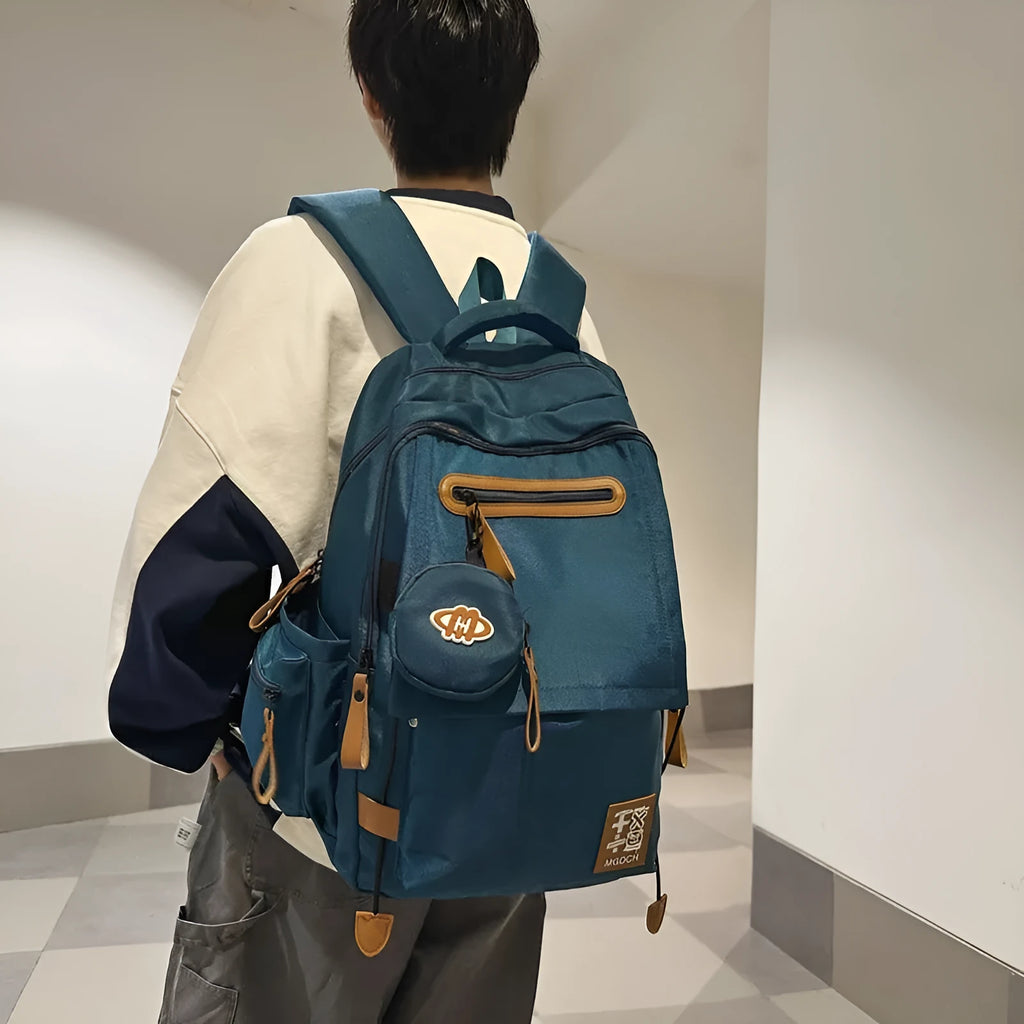 Large black nylon backpack for middle school students with curved shoulder straps and street style sewing details