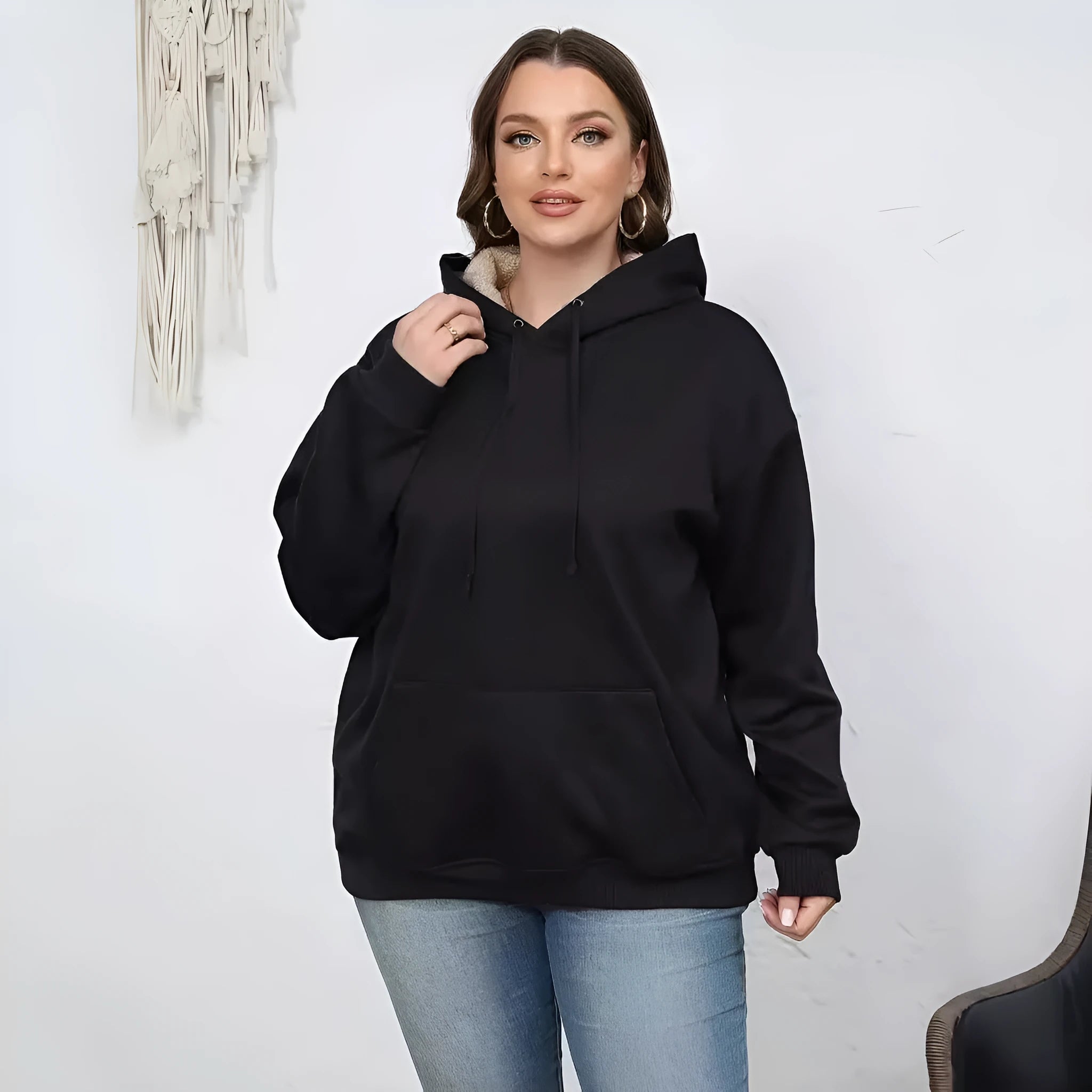A woman's loose-fit hooded sweater with a raised 3D pattern, shown in a wine red colour.