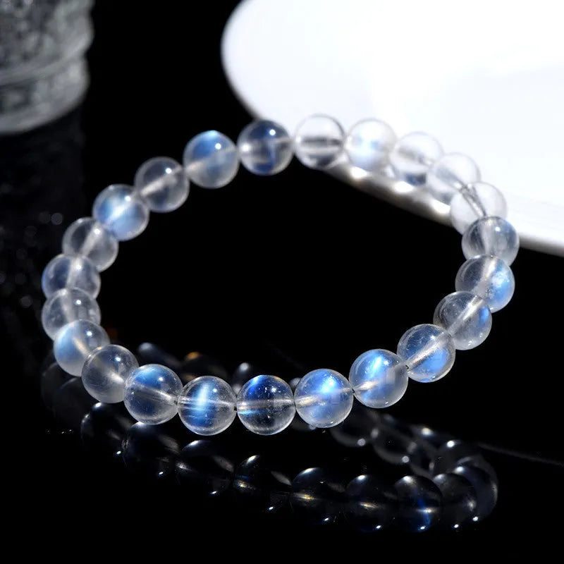 Natural cream body blue moonlight crystal bracelet on a wrist, showing single circle format.