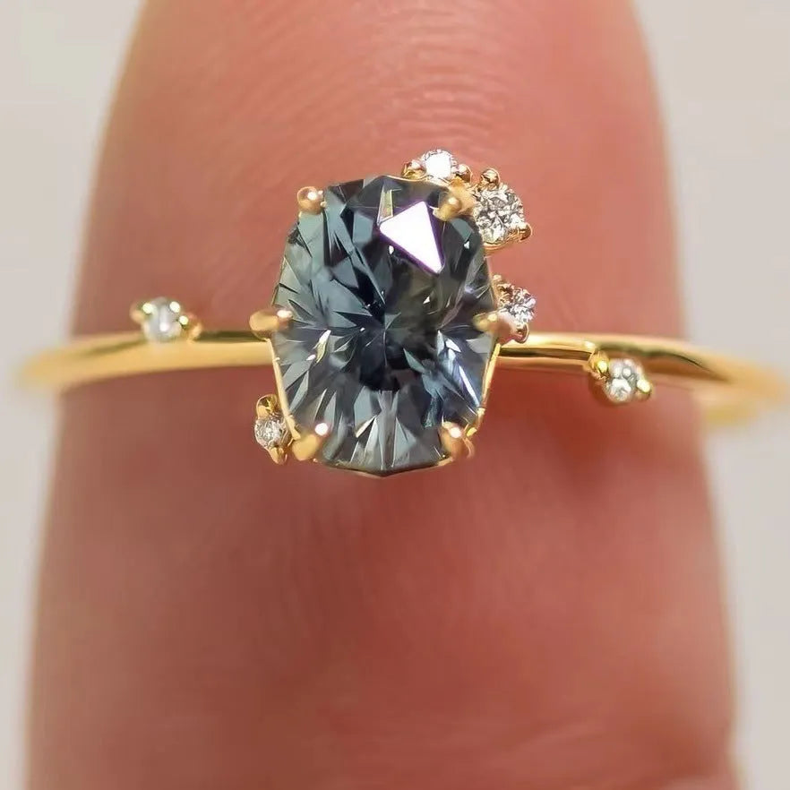 Gold plated women's flower ring with a green zircon stone, shown in sizes 6 to 10.