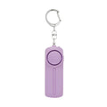 Pink and blue compact personal safety alarm with key ring, showing LED light and activation pin.