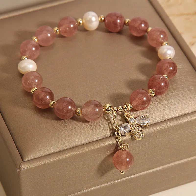 Women's bracelet with freshwater pearls, strawberry quartz beads, zircon accents, and an alloy clasp.