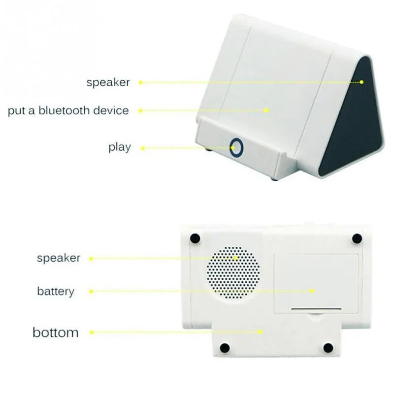Black and white wireless mini Bluetooth speaker with charging cable.